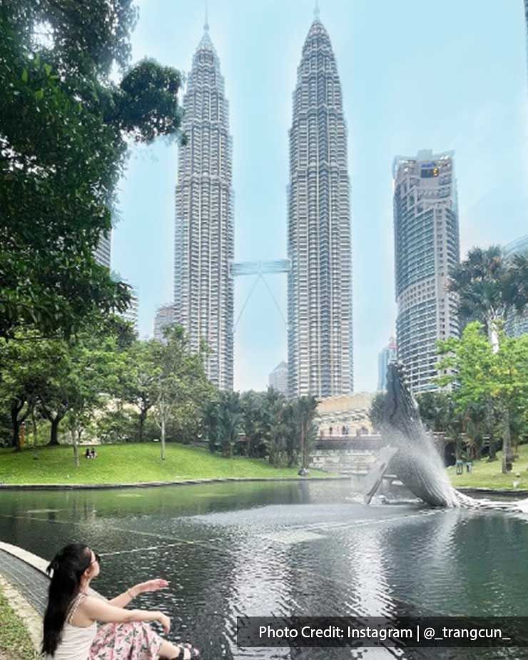 A girl enjoying the peaceful view by a fountain near Petronas Twin Towers close to Imperial Lexis Kuala Lumpur