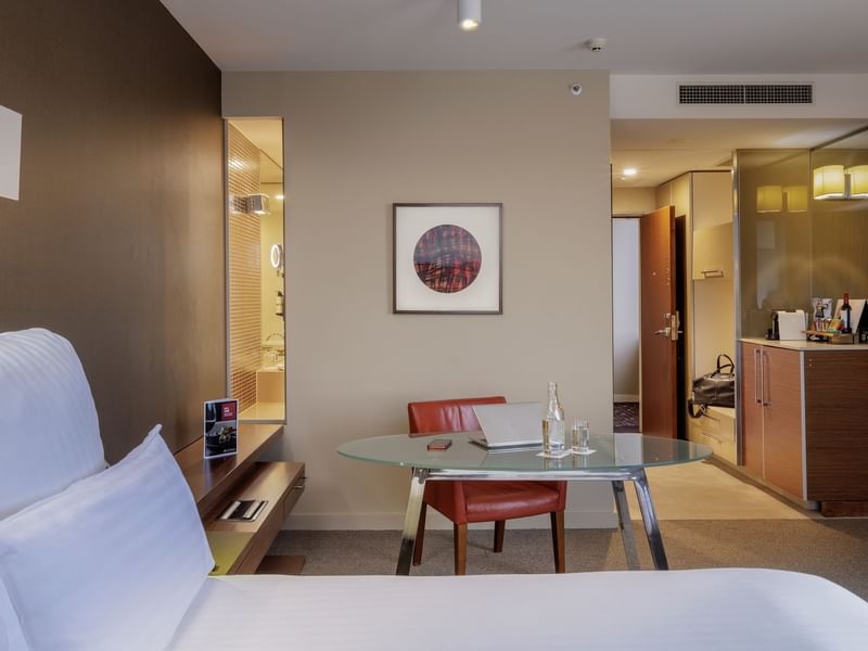 Work desk by the bed and wall-mounted artwork in Pullman Executive Room at Pullman Sydney Olympic Park