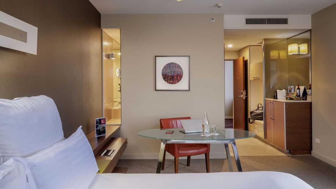 Work desk by the bed and wall-mounted artwork in Pullman Executive Room at Pullman Sydney Olympic Park