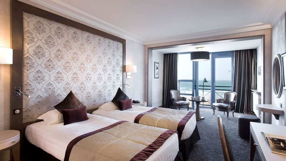 Twin beds in Croisiere Prestige Room with a Sea view at Le Grand Hôtel des Thermes