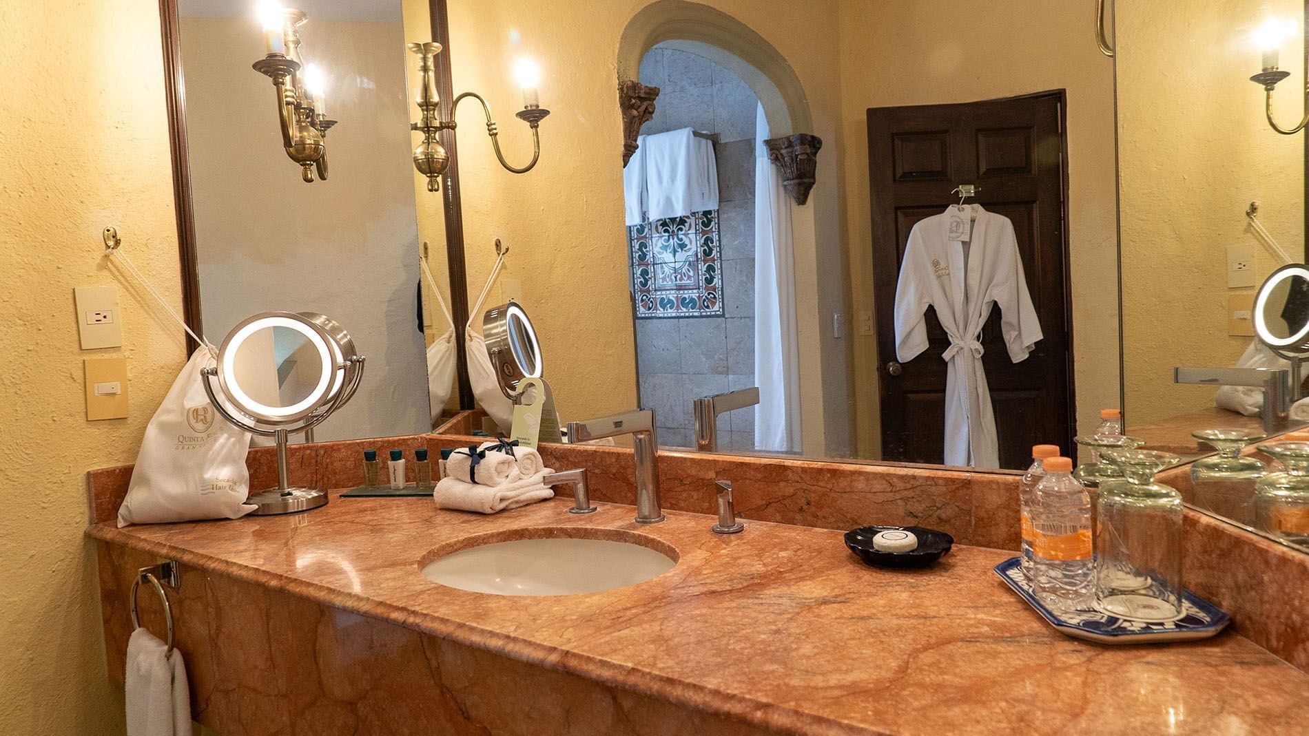 King Governor Suite marble vanity with lighted mirrors and luxury toiletries at Quinta Real Aguascalientes