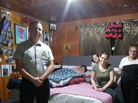 family posing for picture in room