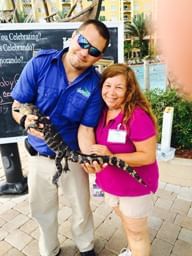 Couple holding a baby alligator near Lake Buena Vista Resort Village & Spa