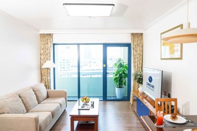 Living room with coffee table, couch, TV at Hanoi Daewoo Hotel