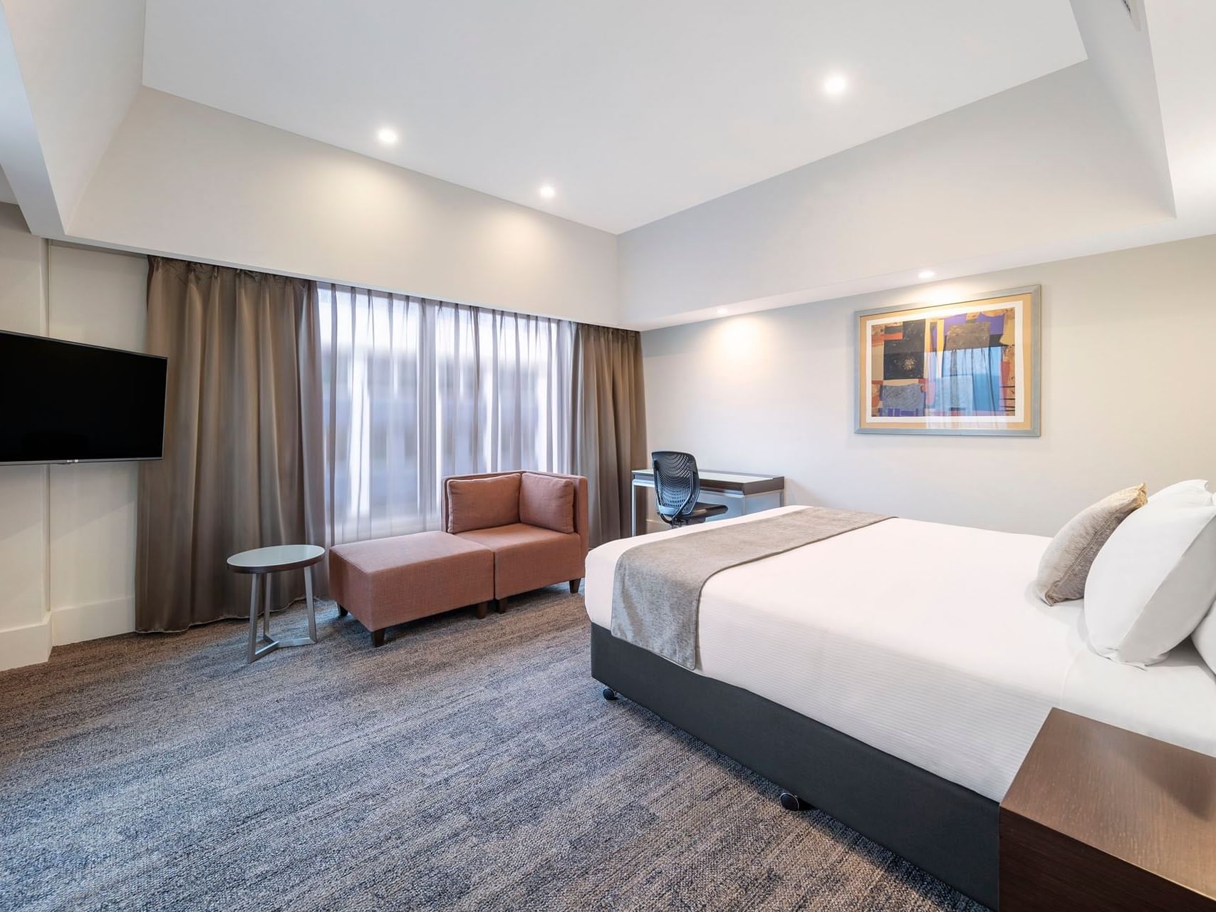 Bed, sofa & Tv in Premium Room at James Cook Grand Chancellor