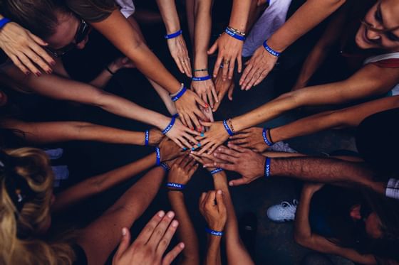 People hands in a huddle at Hotel Mont Gabriel Resort & Spa