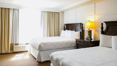 two white beds in hotel room