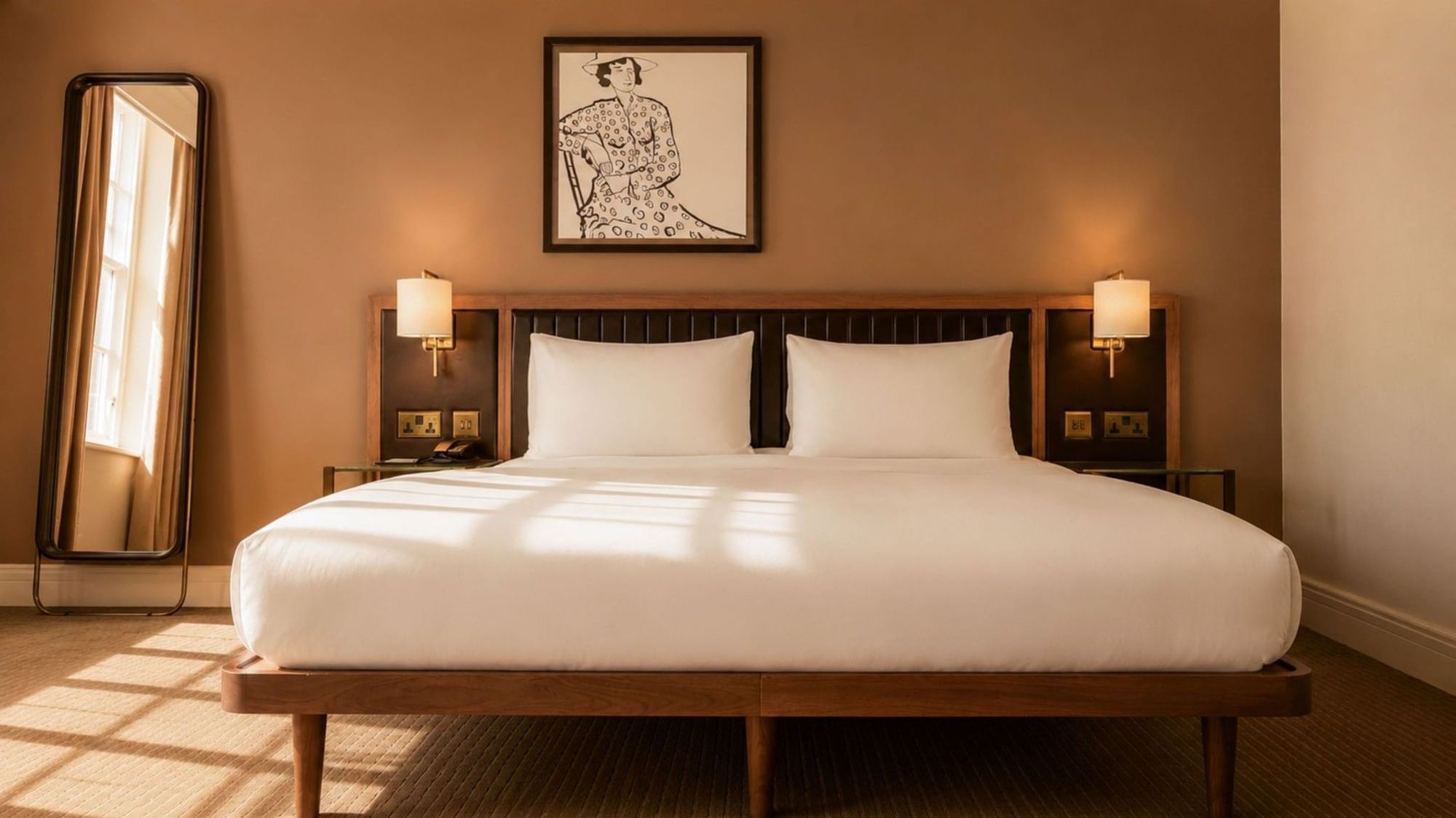 Nightstands and wall-mounted lamps by the cozy bed in the Collection Premium Room with carpeted floors at The May Fair Hotel