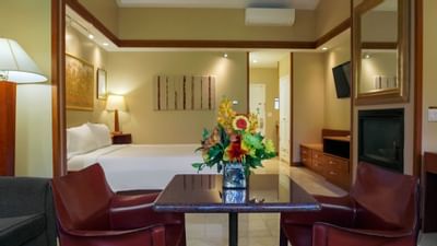 flowers on table next to bed