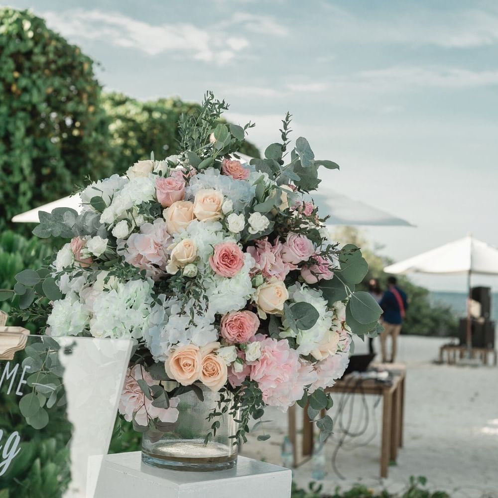 Close-up of a flower bouquet by a table on the beach near Waikiki Resort Hotel by Sono