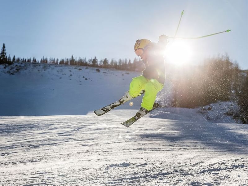 Skier flying through the air in Nassfeld, Falkensteiner Hotels