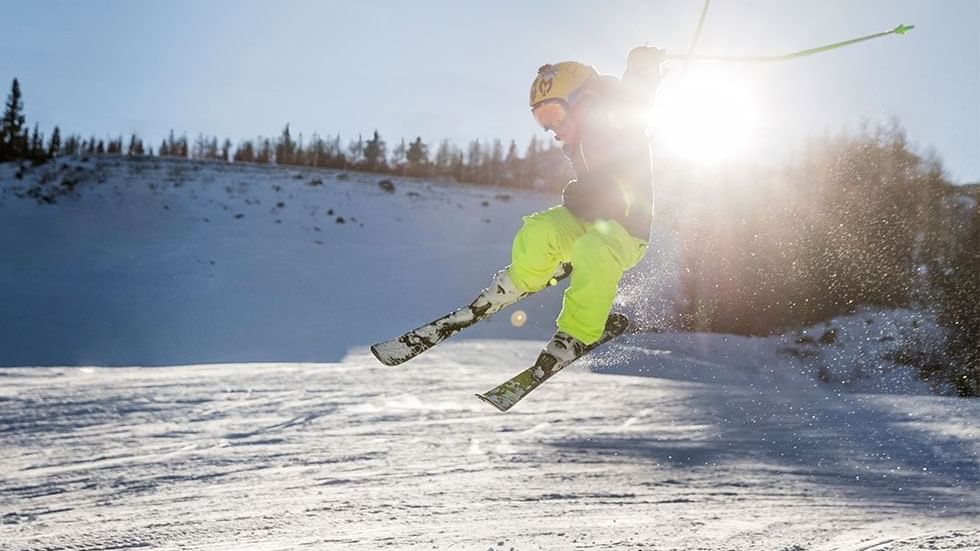 Skier flying through the air in Nassfeld near Falkensteiner Hotel Sonnenalpe