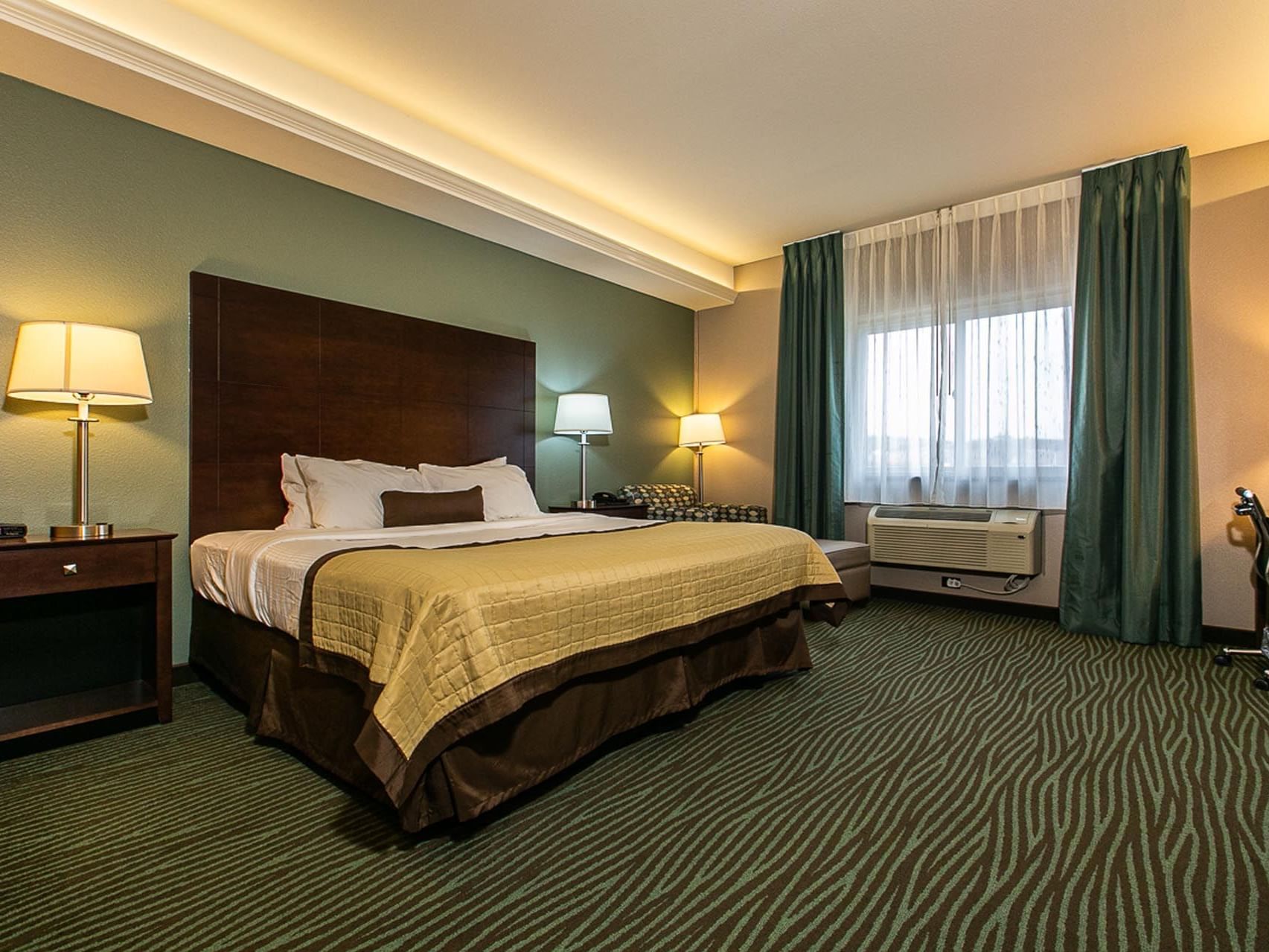Cozy bed with lamps and carpeted floor in King Resort View at Off Shore Resort