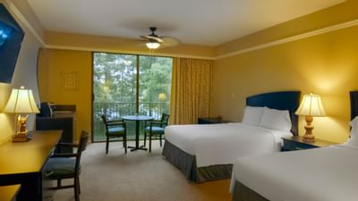 two beds in yellow room with sliding doors