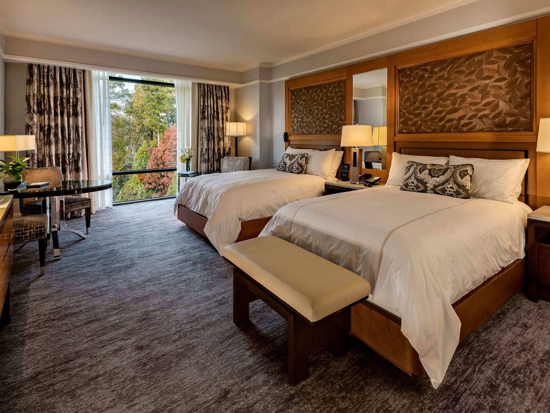 Twin beds in Premier Room, overlooking the naturally landscaped grounds at The Umstead Hotel and Spa