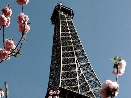 Closeup on Eiffel Tower upper part near Hilton Paris Opera