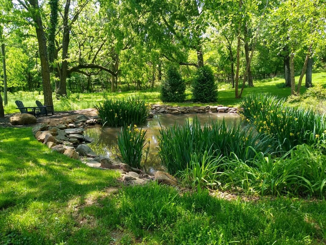 Relaxing garden with a pond and lounge area near The Inn at Willow Grove