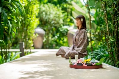 Lady meditating outdoors amid lush greenery at The Saujana Hotel Kuala Lumpur