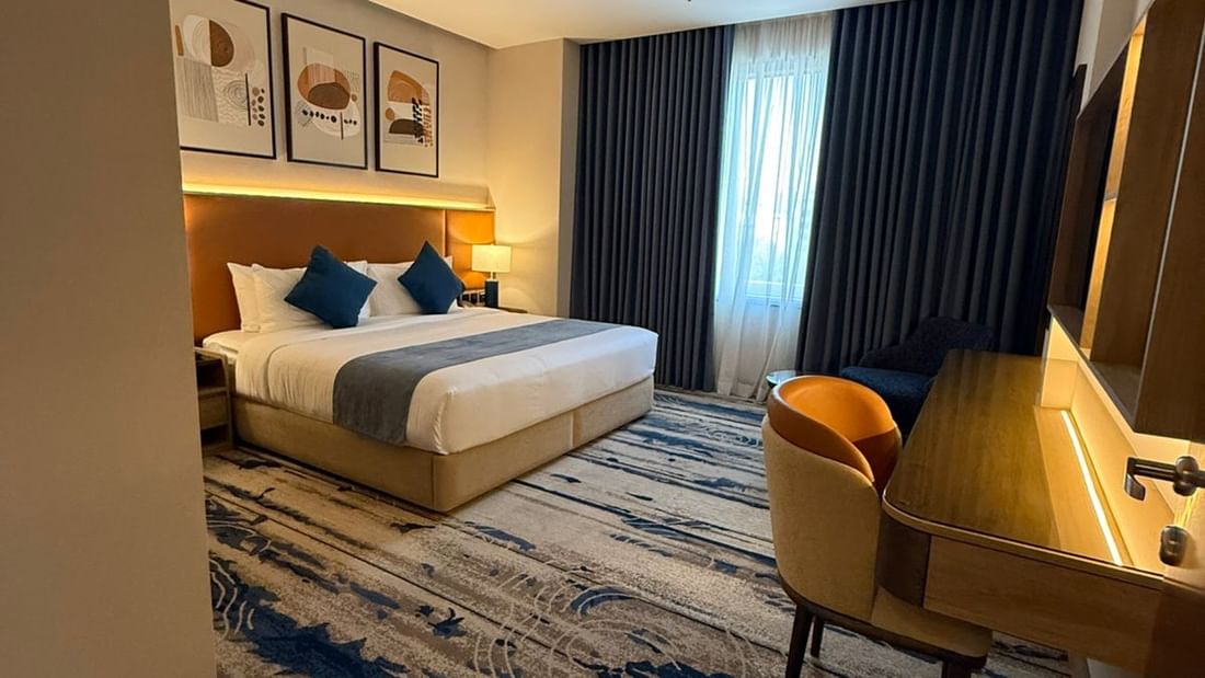 Work desk beside the bed and window-side couch in Bridal Suite at Warwick Jeddah Hotel & Spa