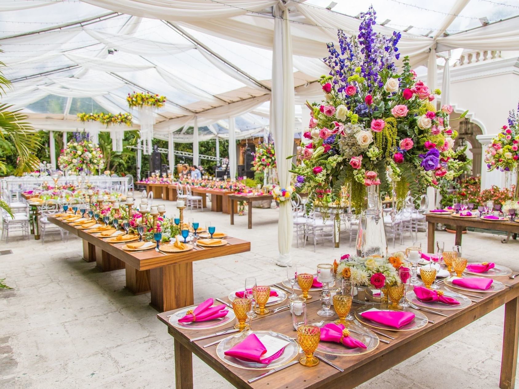 Colorful flowers & tables arranged for an event in La Plazuela at Pensativo House Hotel