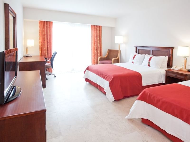 Beds, desk & TV in the Estandar Double Room at Gamma Hotels