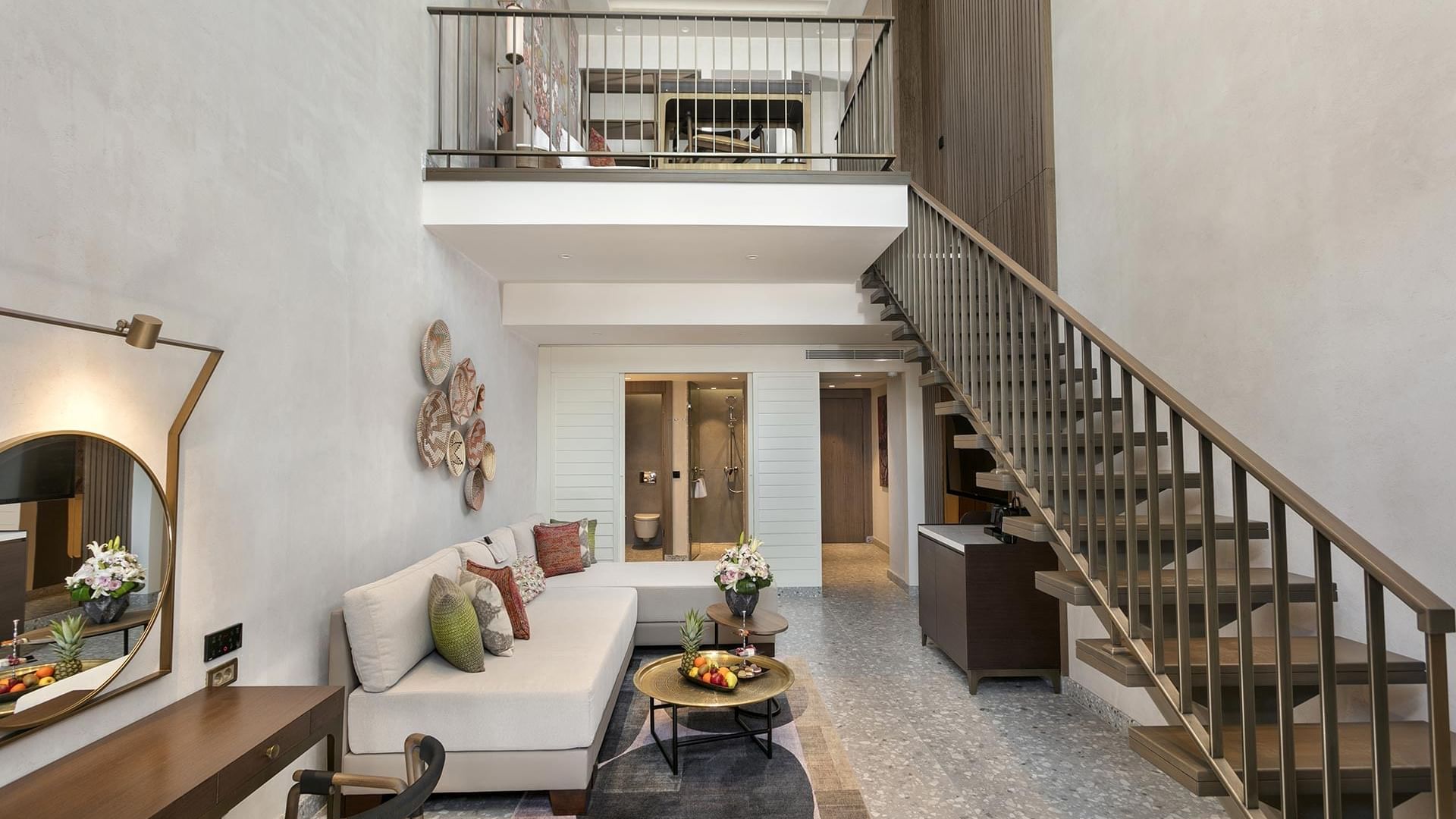Living room with TV and staircase in Superior Duplex Swim-up at Cullinan Belek
