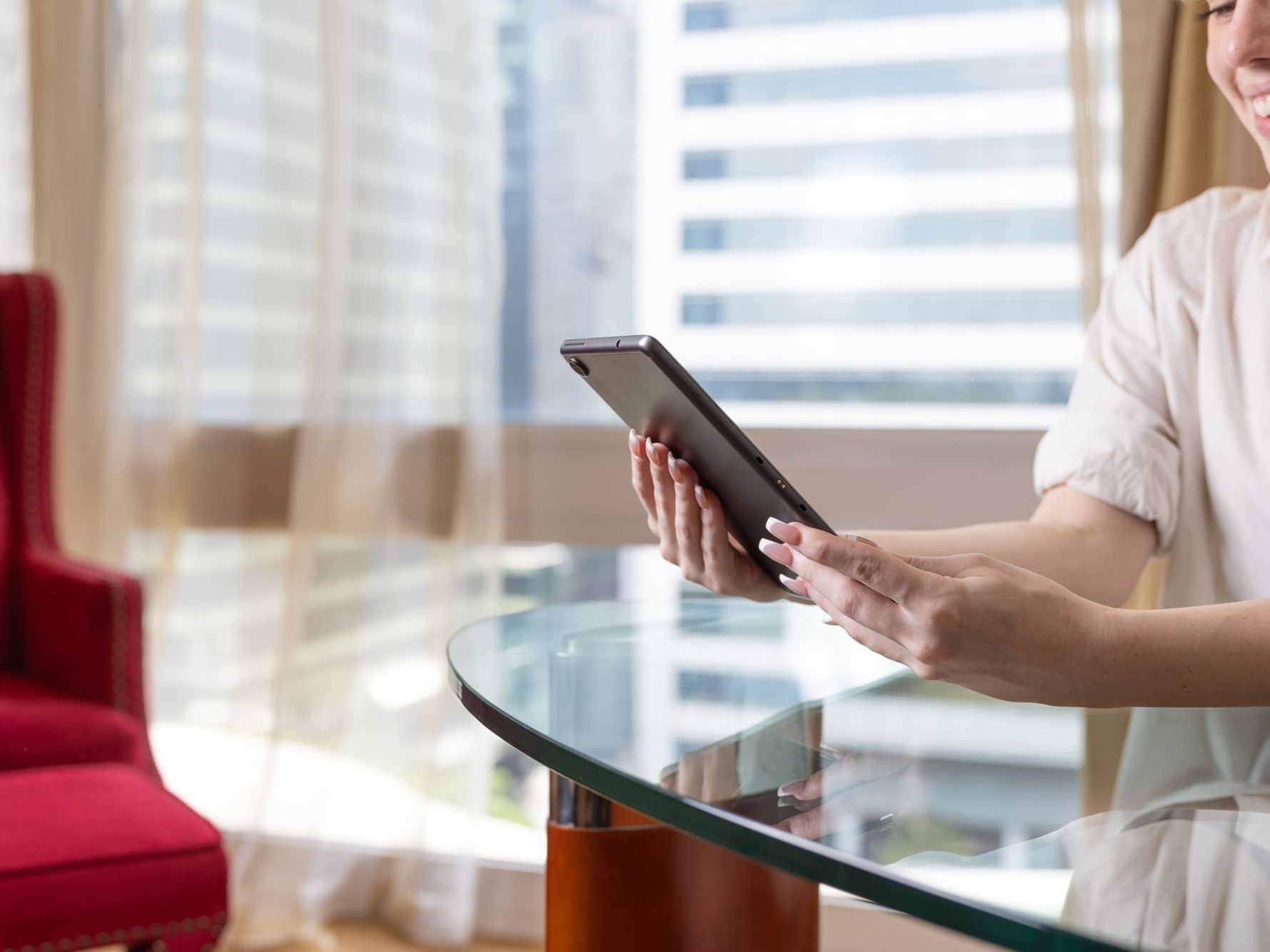 Girl is using her mobile phone in Deluxe City view Room at Royal on the Park Hotel