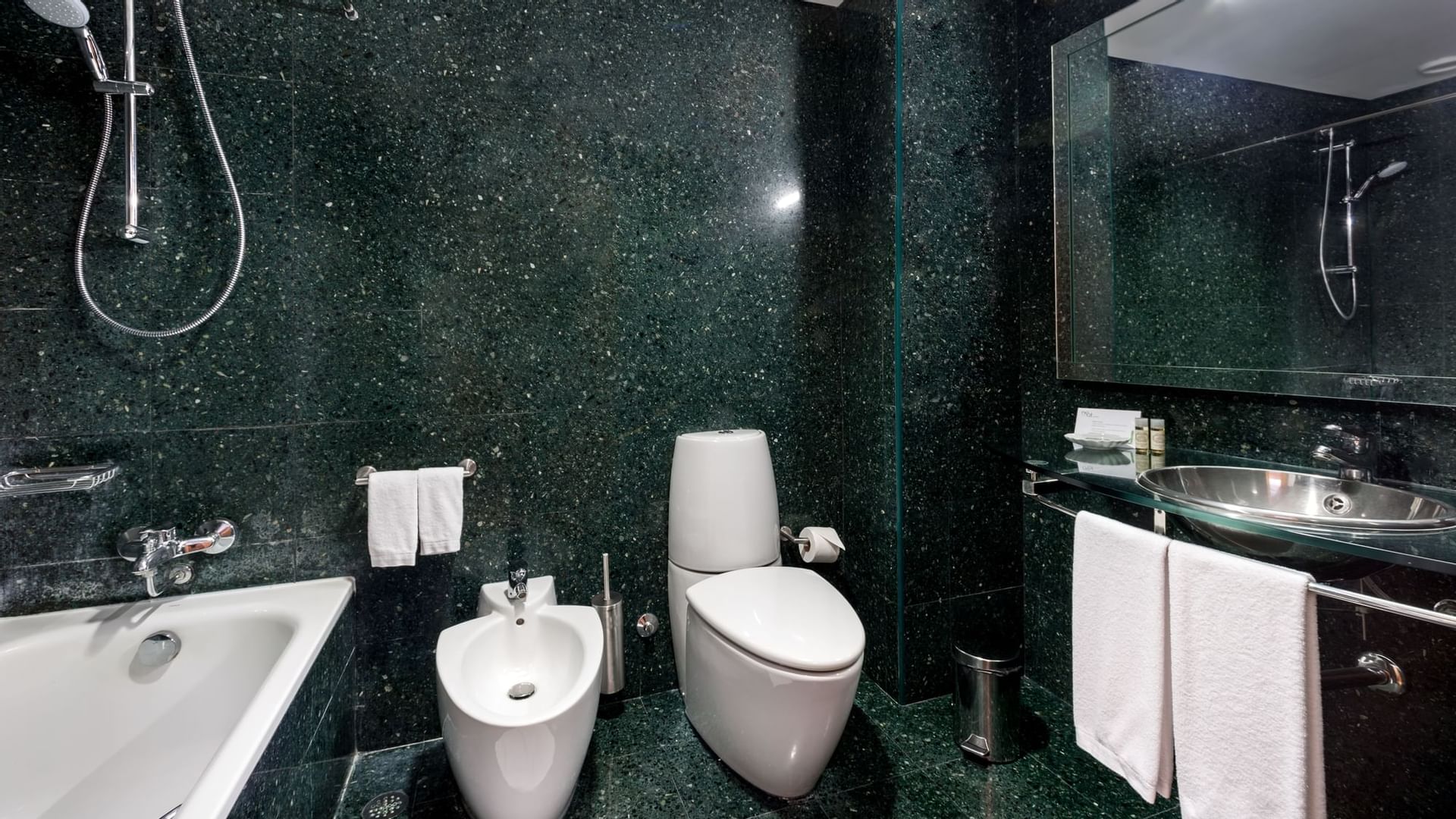 Dark interior & white fittings in bathroom, Bensaude Hotels