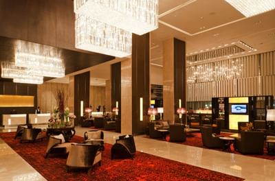 Chandelier, chairs & reception area in the lobby at Eastin Hotels