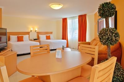 Twin beds, dining table in Junior Suite at Araiza Hotel Palmira