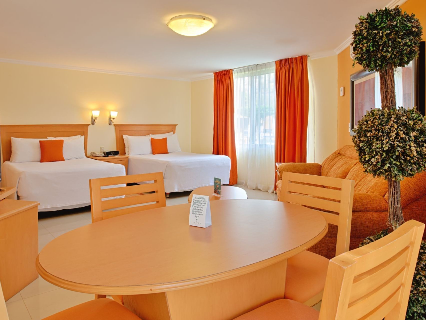 Twin beds, dining table in Junior Suite at Araiza Hotel Palmira