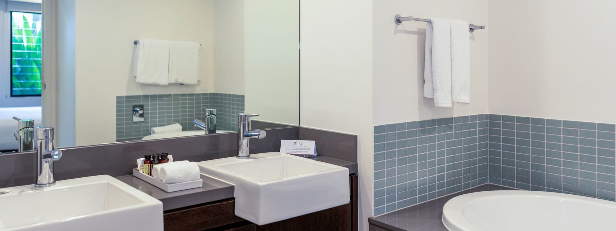 Vanity area with bathtub in Two-Bedroom Apartments at Pullman Port Douglas