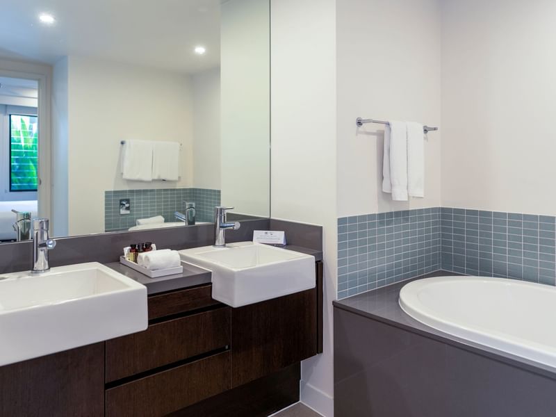 Vanity area with bathtub in Two-Bedroom Apartments at Pullman Port Douglas