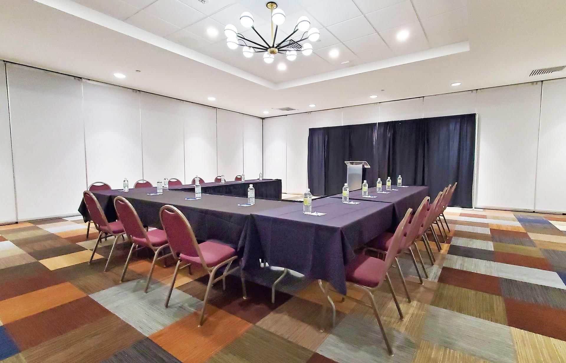 U-shaped table setup with modern decor in a meeting room at The Barrymore Hotel