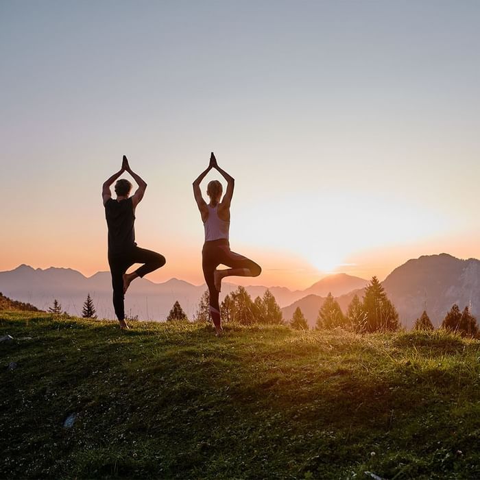 A couple doing yoga in the morning at Falkensteiner Hotels