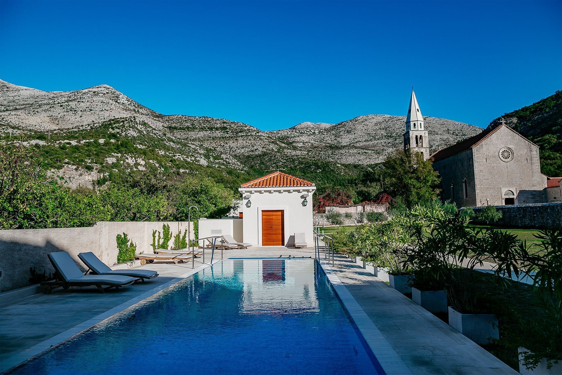 The Hotel pool with sun beds at Pervanovo Vila Riva Apartments
