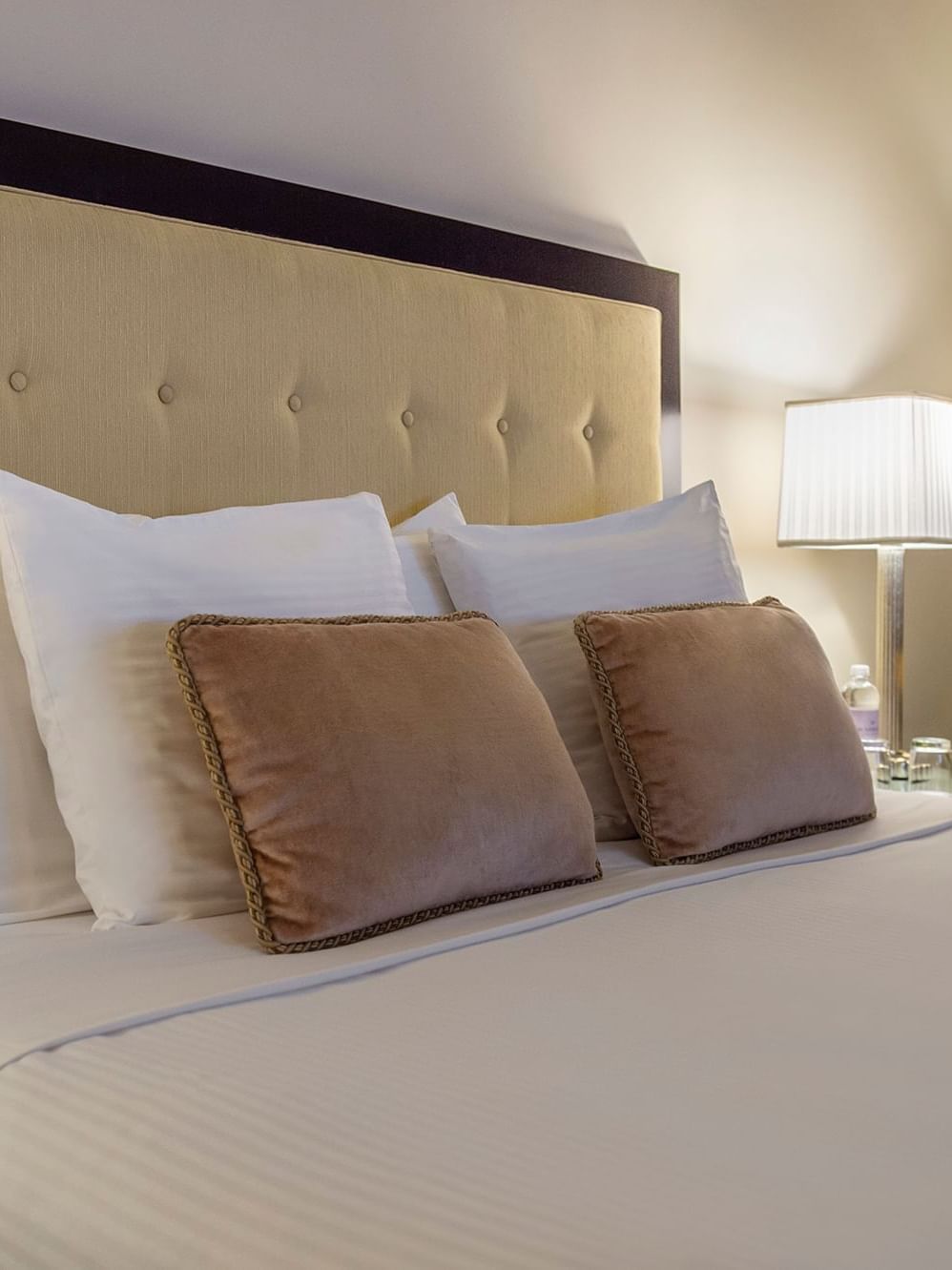 A comfortable king-sized bed with white linens and pillows at Warwick New York