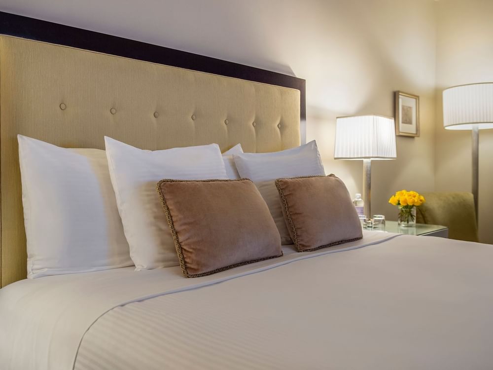 A comfortable king-sized bed with white linens and pillows at Warwick New York