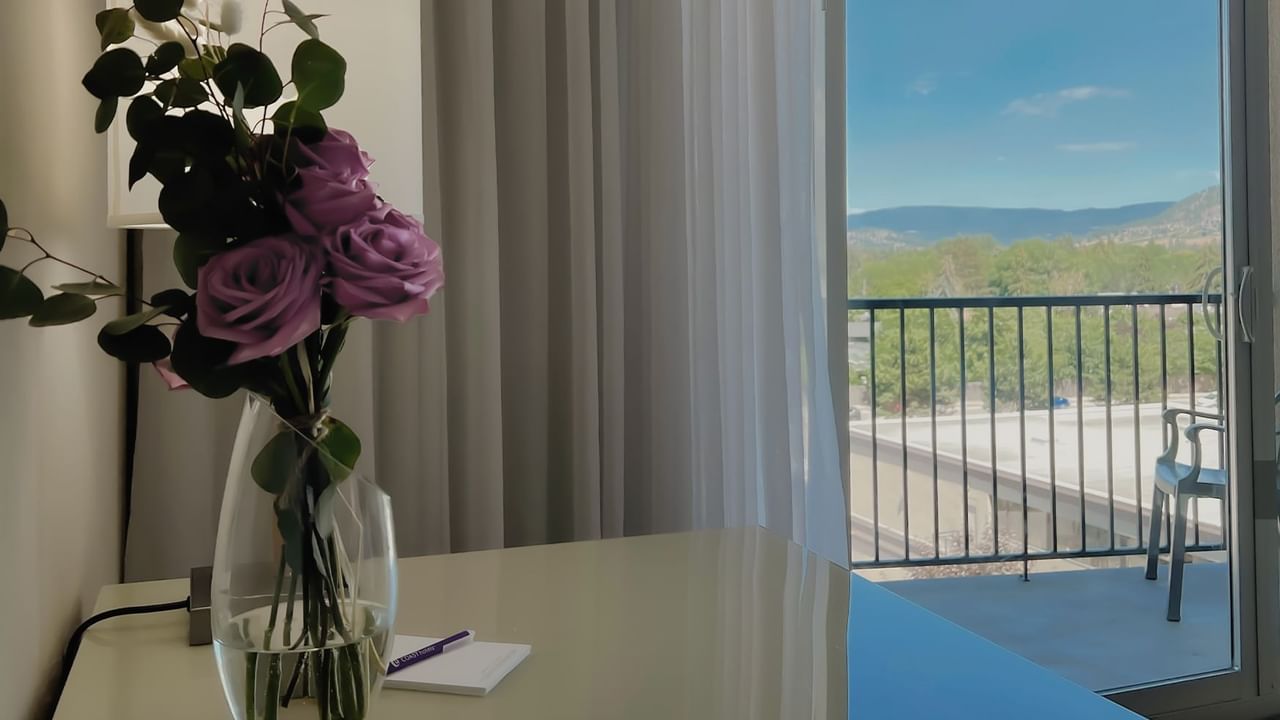 Vase of roses on counter top with balcony view in background