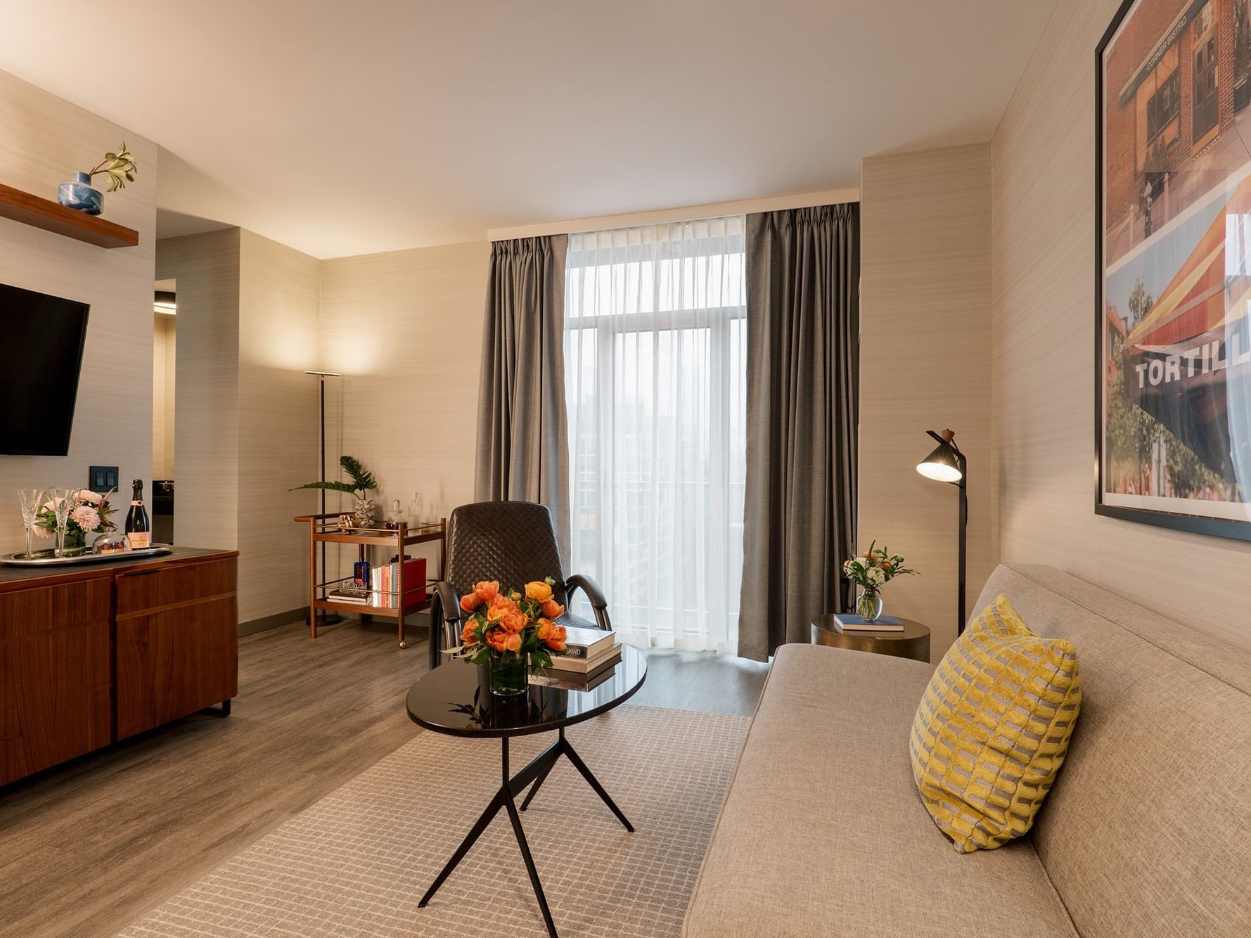 Gansevoort Suite living area with couch, table, and chair at Gansevoort Meatpacking NYC in New York.