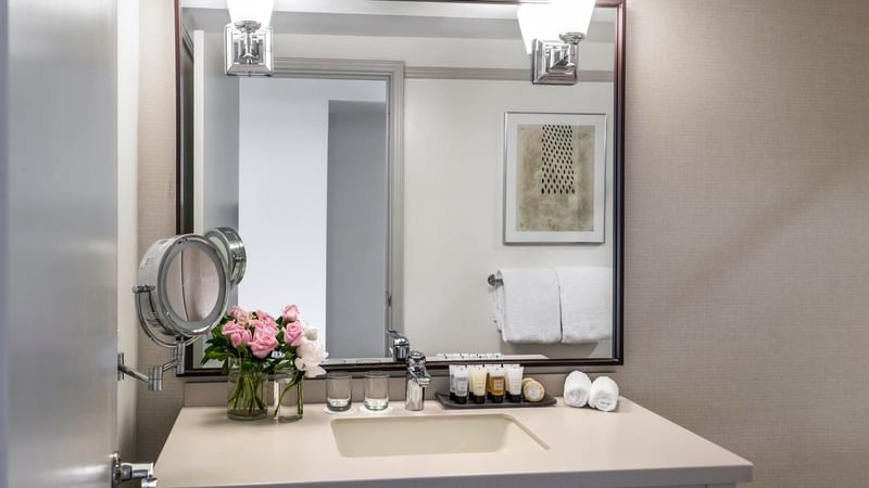 Bathroom vanity with mirror in Executive Suite at Warwick Denver