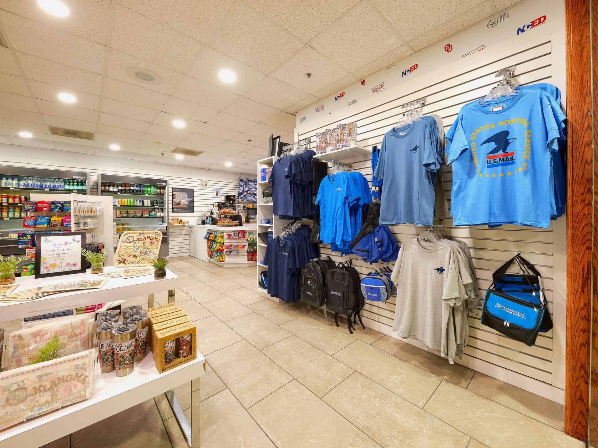 NCED Hotel and Conference Center gift shop with shelves displaying merchandise, t-shirts and bags.