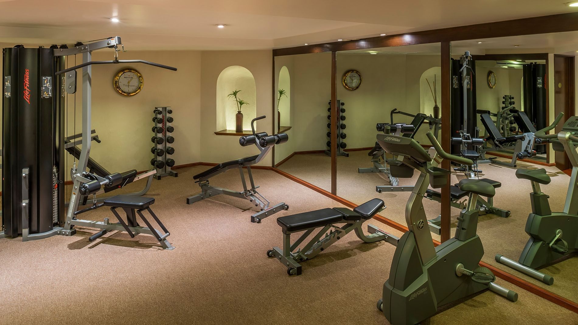 Modern fitness center featuring LifeFitness equipment and mirrored wall decor at Quinta Real Zacatecas