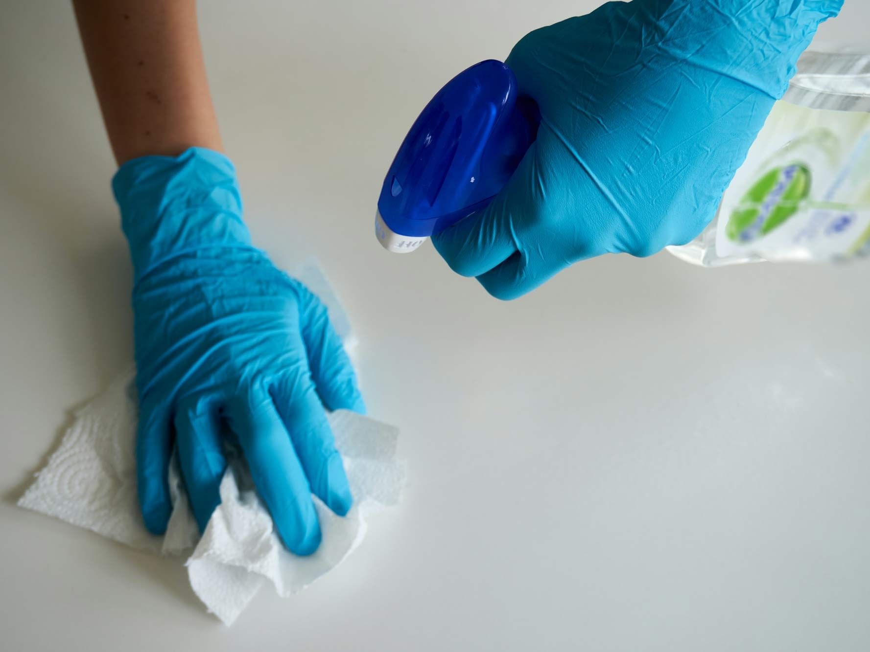 An employee cleaning the furniture at New Haven Hotel