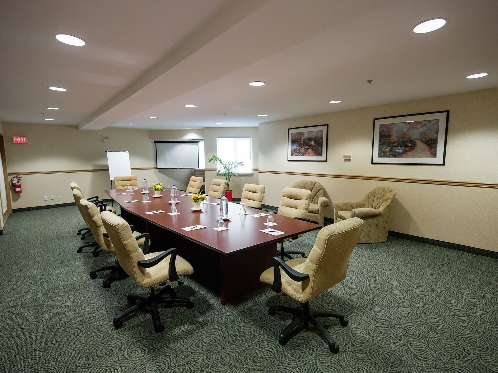 Interior & decor of a conference room with a long table & carpeted floors at Harrison Lake Hotel