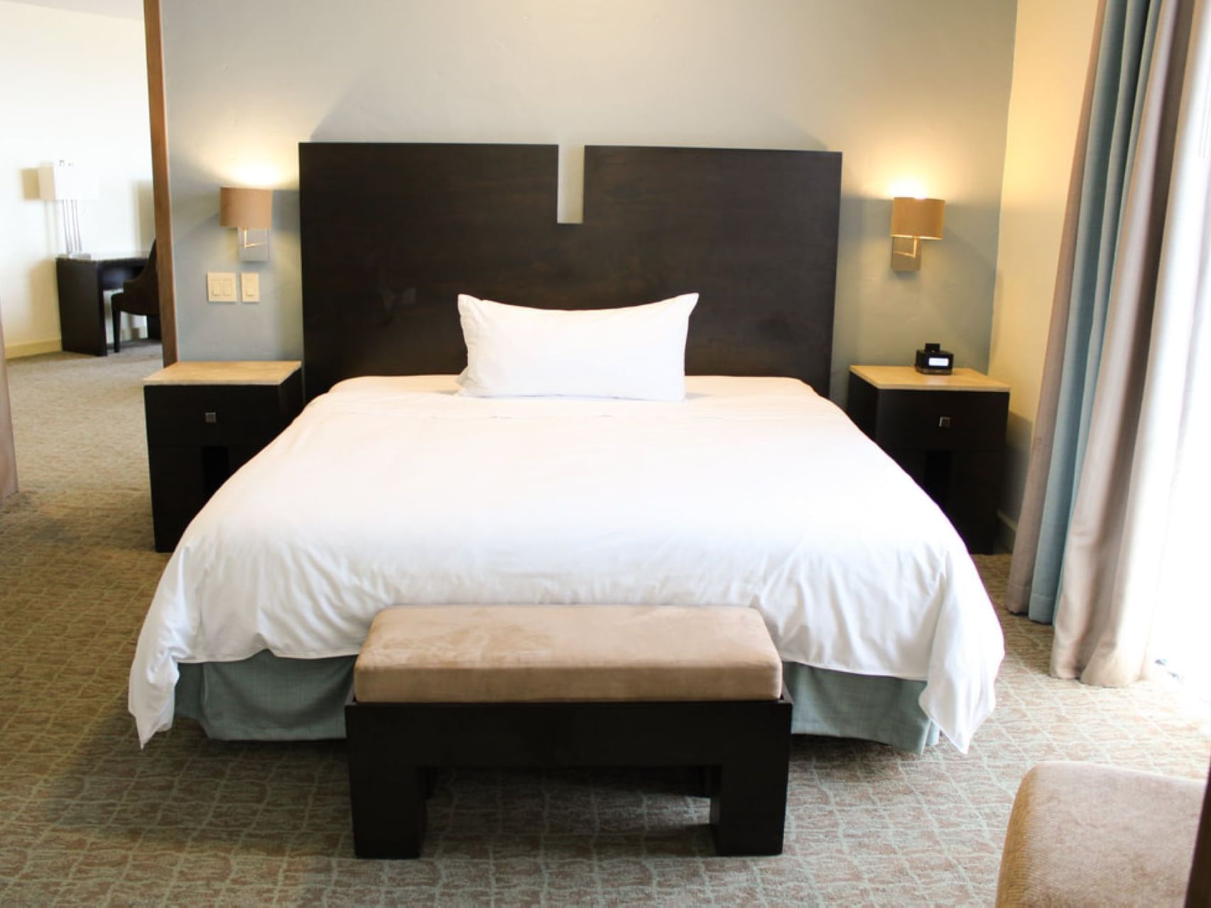 King bed in & stool in Master Deluxe at Hotel Coral y Marina