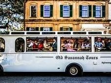 White bus with passengers for Old Savannah Tours at River Street Inn