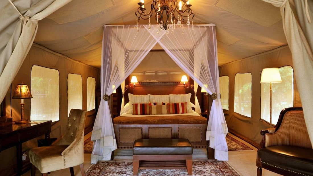 Tent with a King Size Bed and desk at Selous Serena Camp 