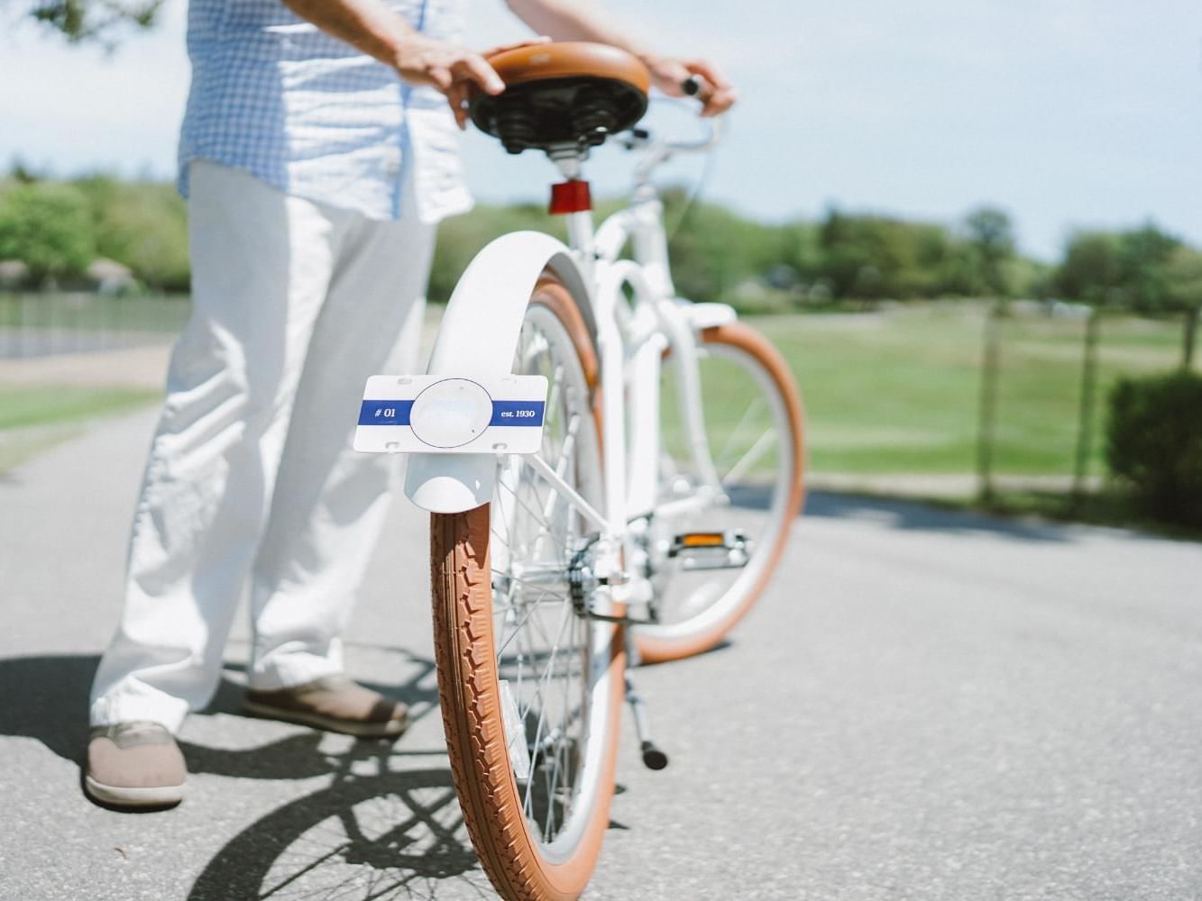 Man standing by a bicycle in the park near Meadowmere Resort