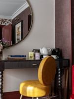 Superior Room decor with modern furniture and floral arrangement at The Capital Hotel, Apartments & Townhouse
